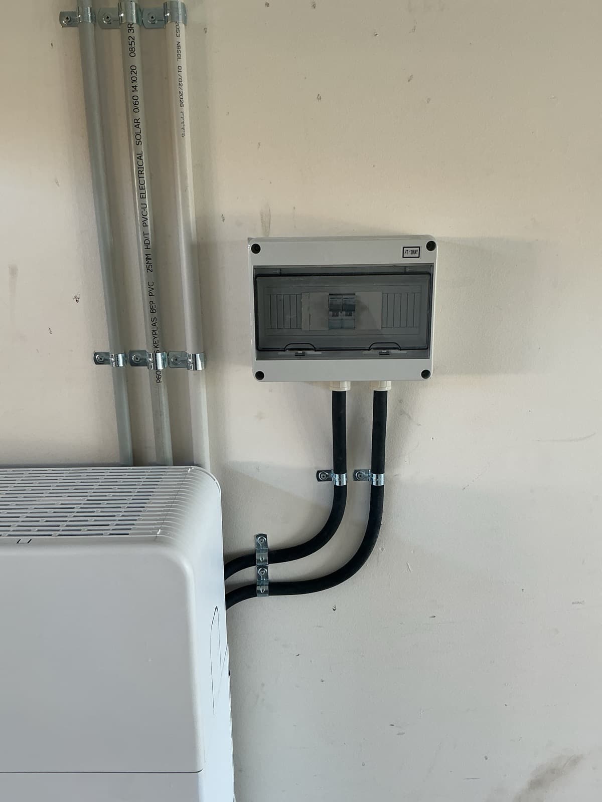 Battery isolator and conduit run beside a home battery